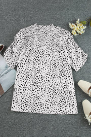 White dalmatian print blouse with shirred yoke and short sleeves