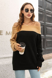 Black and camel asymmetric shoulder-baring knit sweater with ribbed neckline and cuffs.