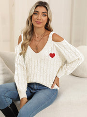White open shoulder cable knit sweater with red heart detail and v-neck