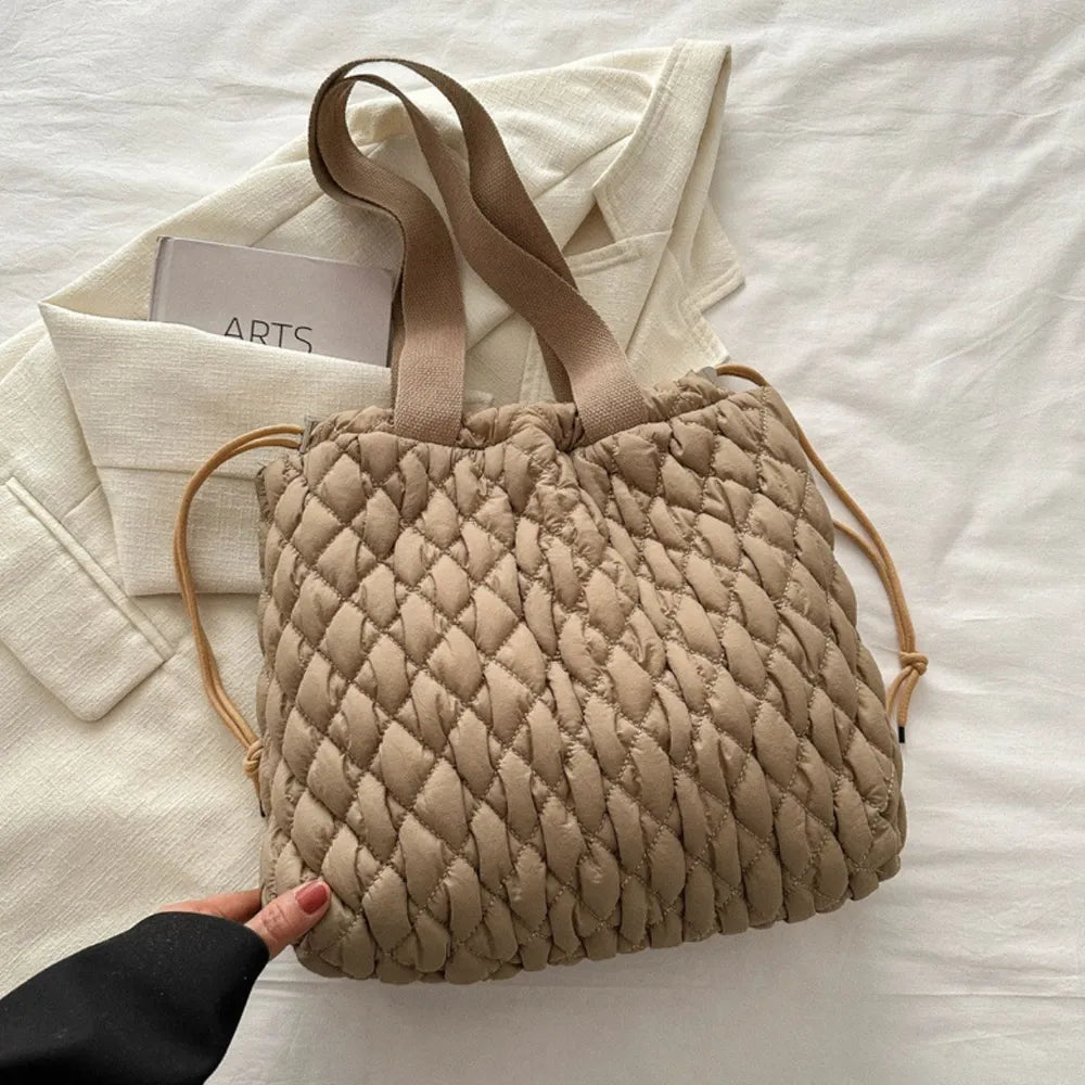 Quilted drawstring carryall bag in Khaki with dual straps and a casual trapezoid shape.