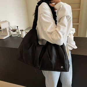 Black ruched handle crescent shoulder bag with ruched strap detail
