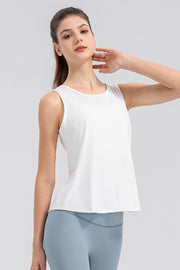 White performance tank top with a curved back panel detail and round neckline.