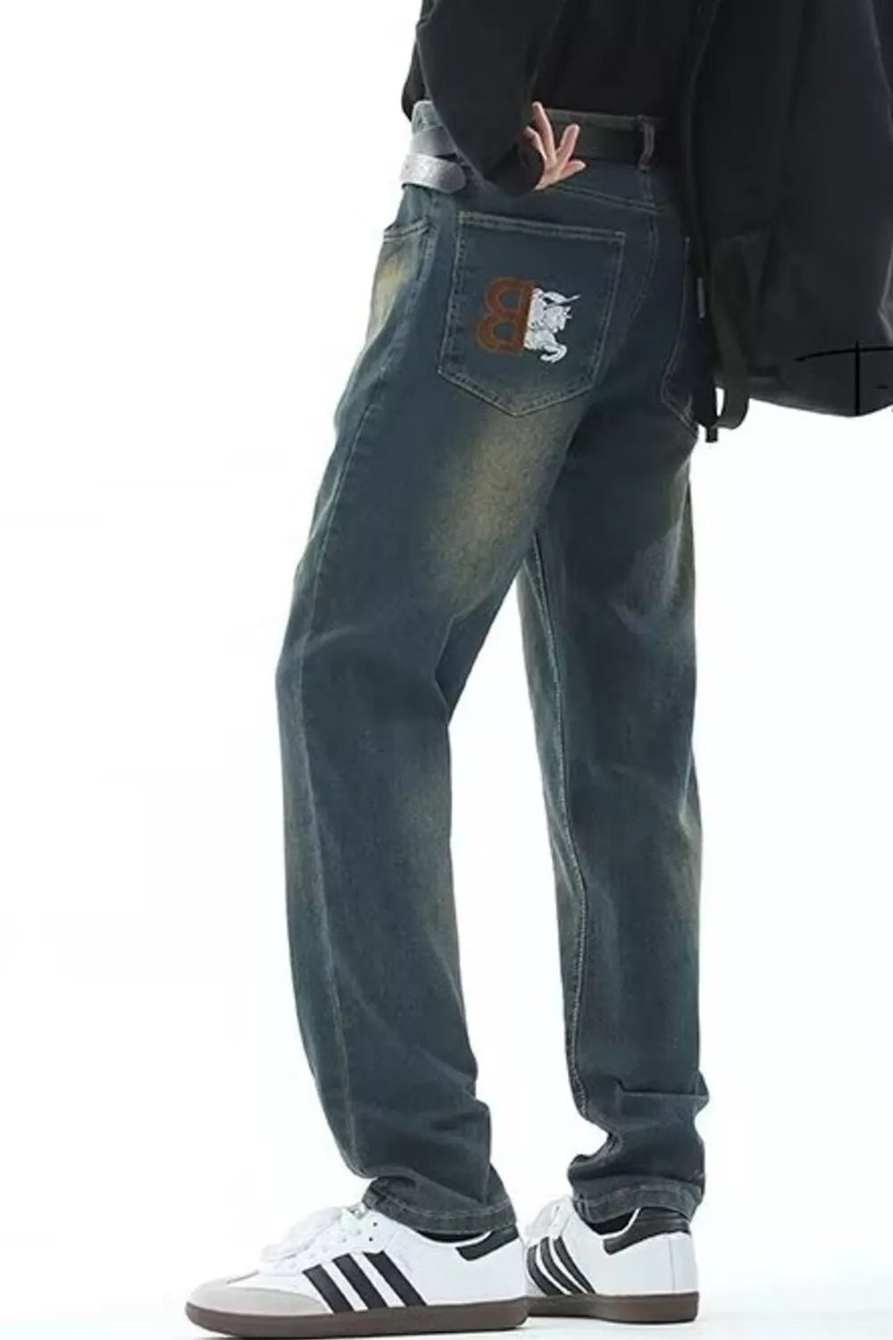 Men's vintage wash straight-leg jeans with embroidered back pocket detail.