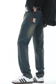 Men's vintage wash straight-leg jeans with embroidered back pocket detail.
