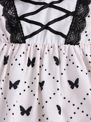 Baby dress with butterfly print, polka dots, black lace trim, and crisscross ribbon detail.