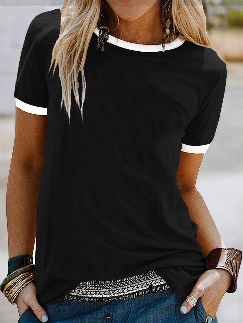Black t-shirt with white contrast trim, relaxed fit, short sleeves.