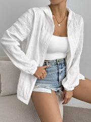 White crinkled lightweight hooded jacket with zip closure and elastic cuffs.