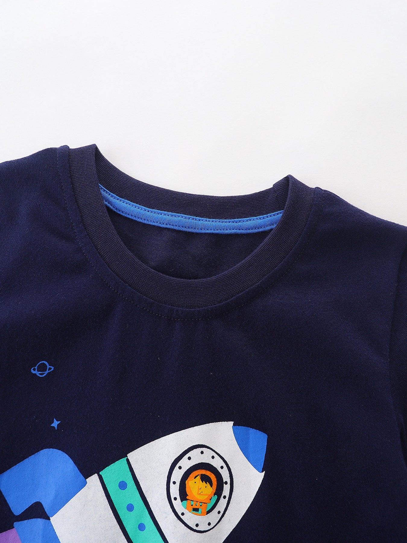 Navy cotton toddler t-shirt with a rocket ship and astronaut graphic.