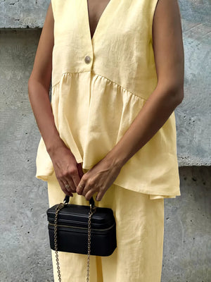 Yellow peplum hem two-piece set with button detail and V-neck top.
