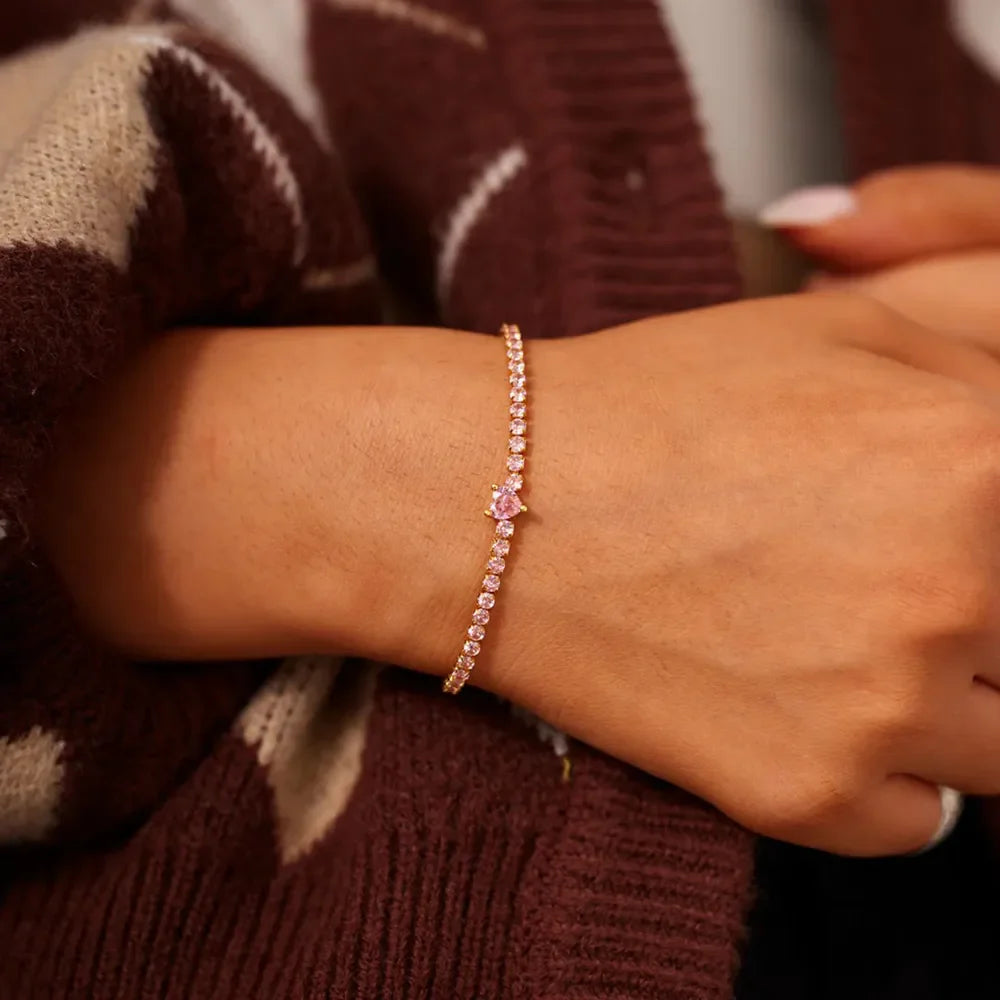 Gold tennis bracelet with pink heart zirconia charm