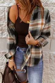 Oversized black plaid shacket with button front, worn open over a black tank top and distressed jeans.