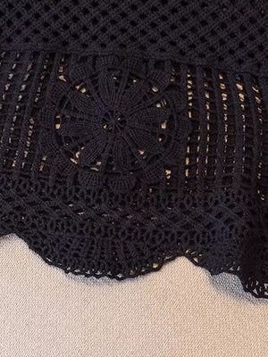 Black crochet tank top with floral overlay detail and scalloped hem.
