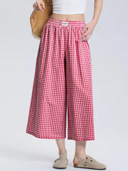 Gingham check wide-leg maternity pants in rose red with an elastic waistband.