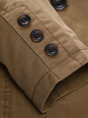 Khaki cotton blazer sleeve detail with three dark buttons and contrast stitching.