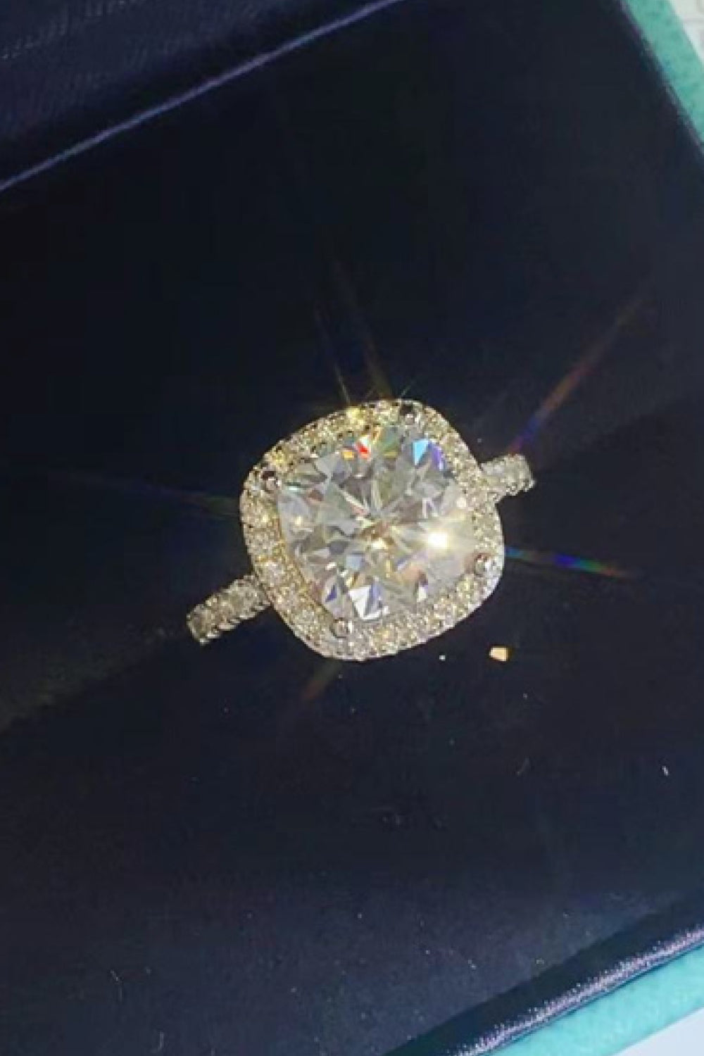 White cushion-cut halo engagement ring with diamond band