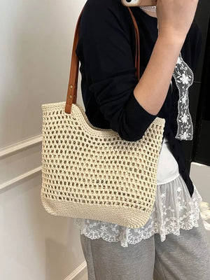 Beige woven straw shoulder bag with leather straps, open knit detail