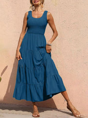 Smocked bodice ruffled maxi dress in dark blue with tiered skirt and square neckline.