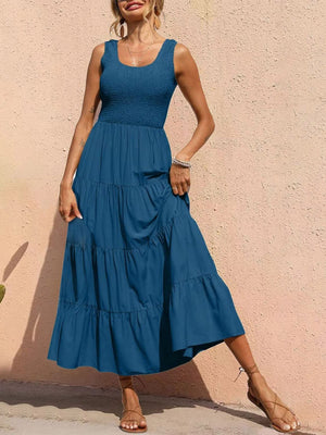 Smocked bodice ruffled maxi dress in dark blue with tiered skirt and square neckline.