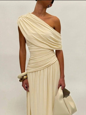 Beige one-shoulder maxi dress with draped bodice and ruching detail.