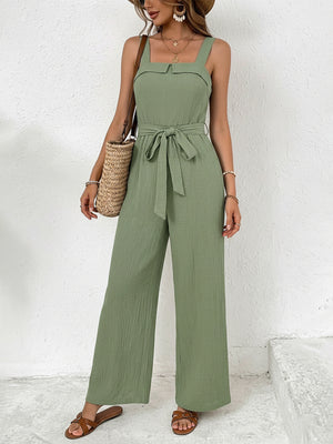 Green crinkled tie waist wide leg maternity jumpsuit with square neckline and wide straps.