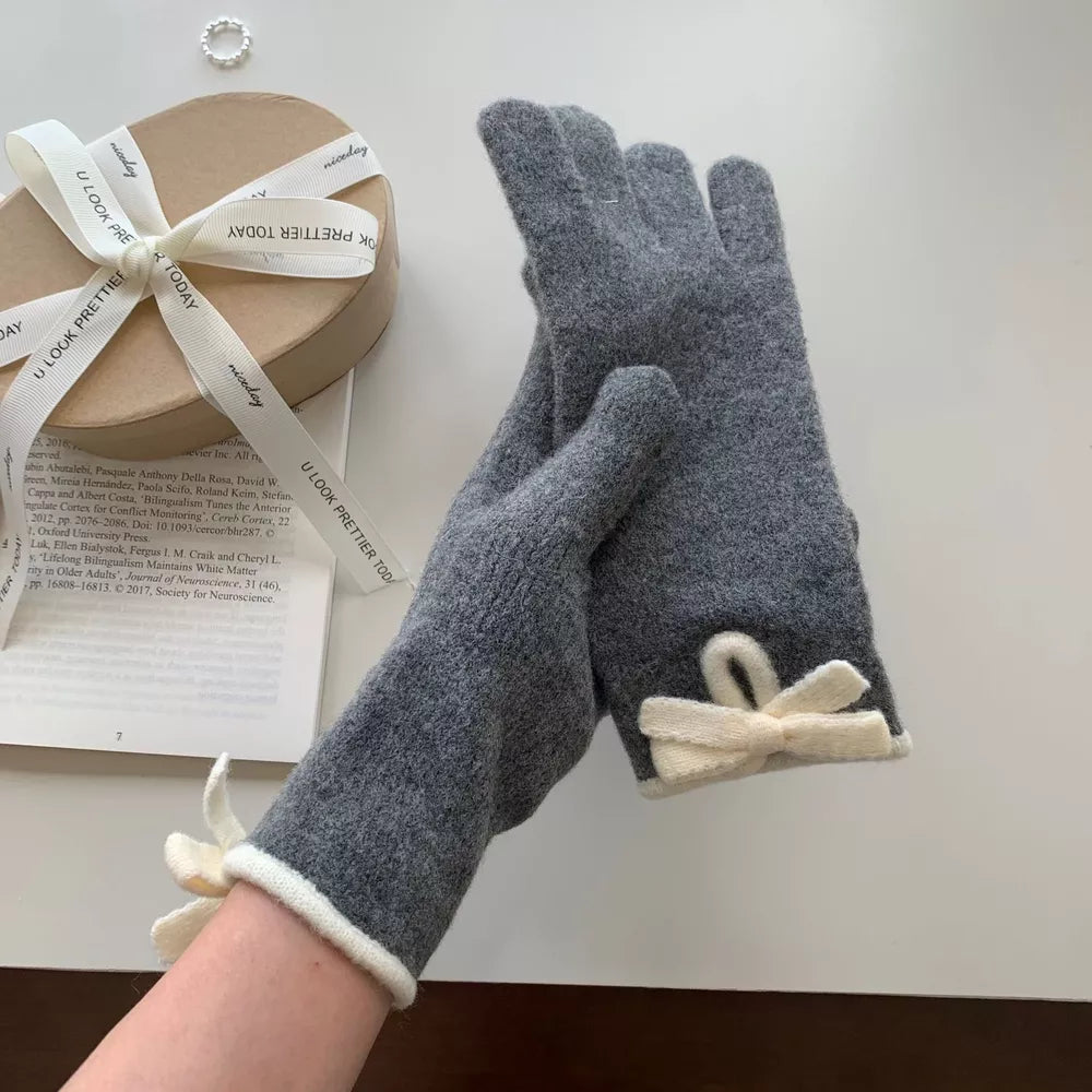 Dark gray knit gloves with cream bows and trim