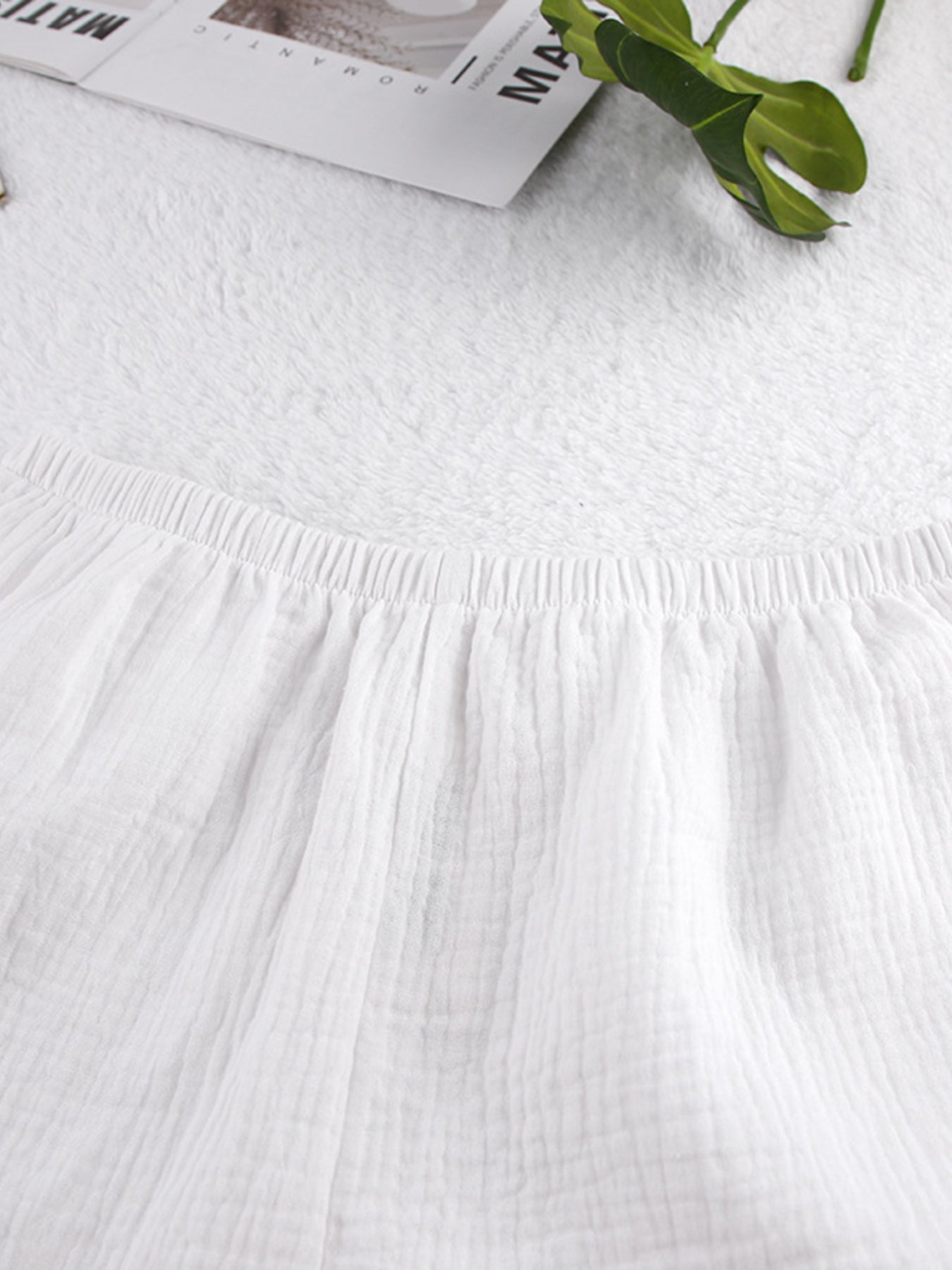 White cotton cami and shorts pajama set with elastic waistband and crinkled texture.