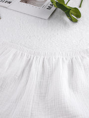 White cotton cami and shorts pajama set with elastic waistband and crinkled texture.