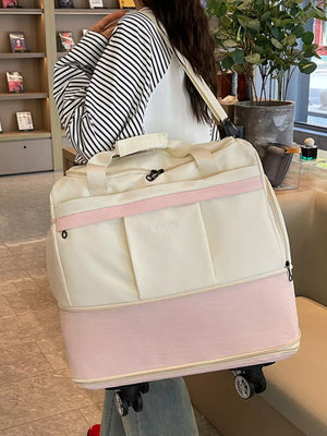 Premium large rolling duffel bag in cream and pink with wheels and handles.