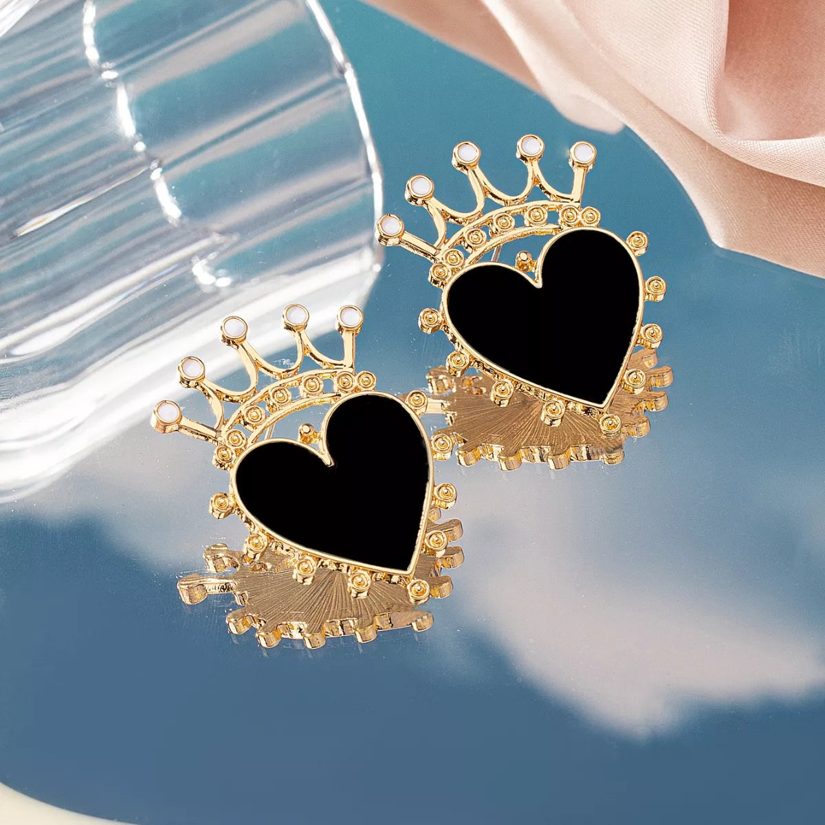 Black heart crown stud earrings with gold trim and white accents