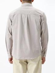 Men's light gray cotton button-down shirt with long sleeves and button cuffs.