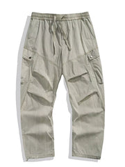 Loose fit khaki cargo pants with drawstring waist and multiple pockets.