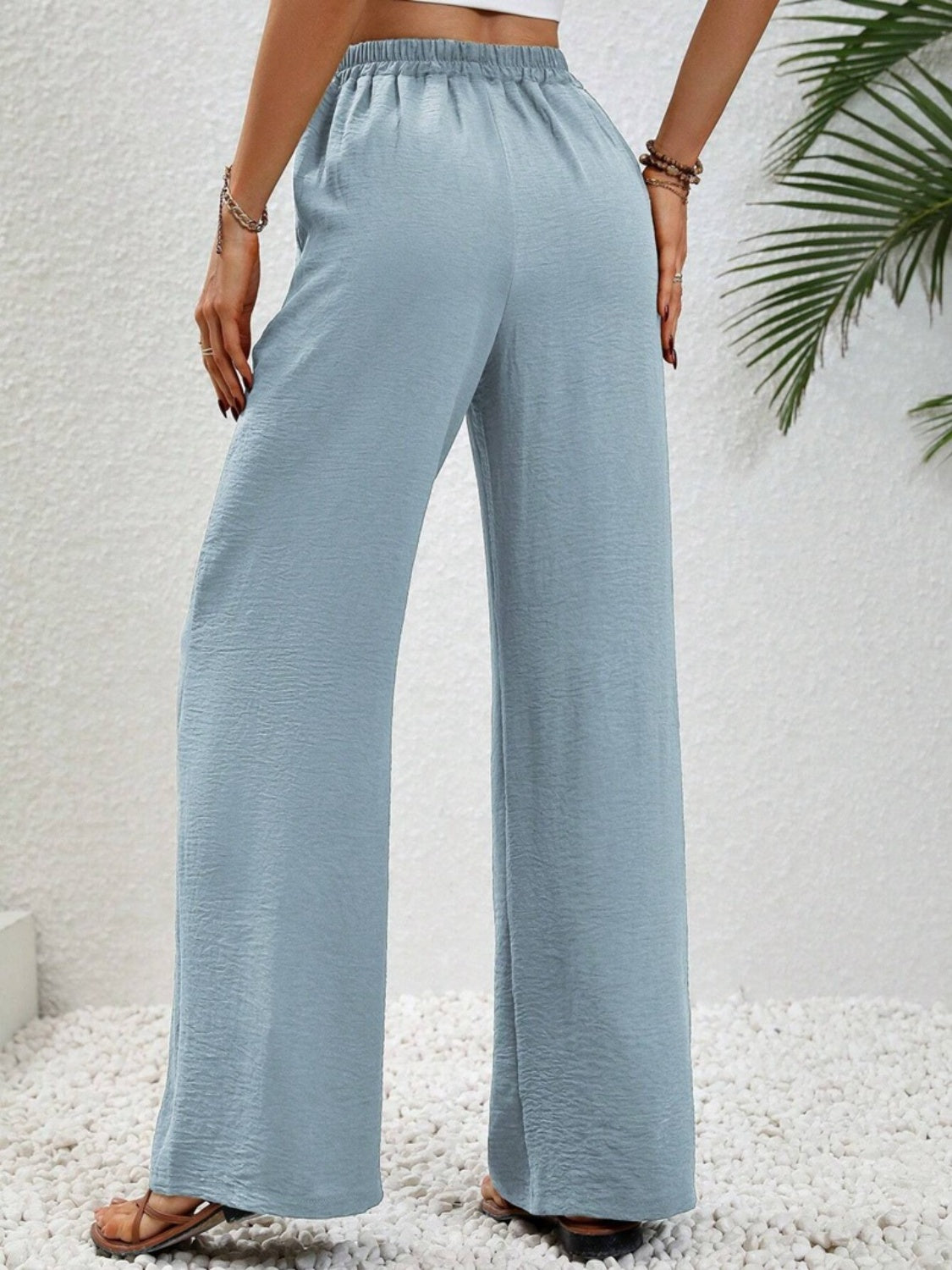 Light Blue textured palazzo trousers with drawstring waist and wide legs.