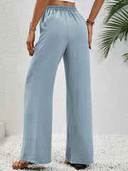 Light Blue textured palazzo trousers with drawstring waist and wide legs.