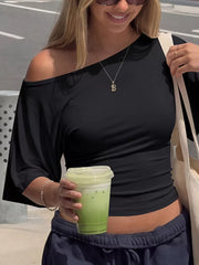 Black draped tie-front t-shirt with dolman sleeves and asymmetrical neckline.