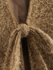 Textured knit tie-front cardigan in dark brown with a fuzzy, open weave and a knot detail.