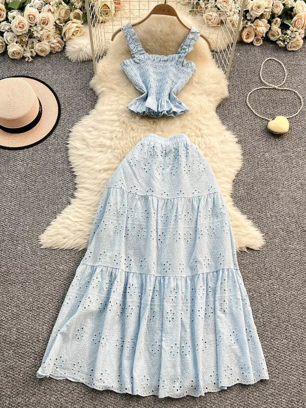 Light blue eyelet crop top with ruffled straps and tiered maxi skirt with elastic waistband.