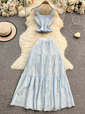 Light blue eyelet crop top with ruffled straps and tiered maxi skirt with elastic waistband.