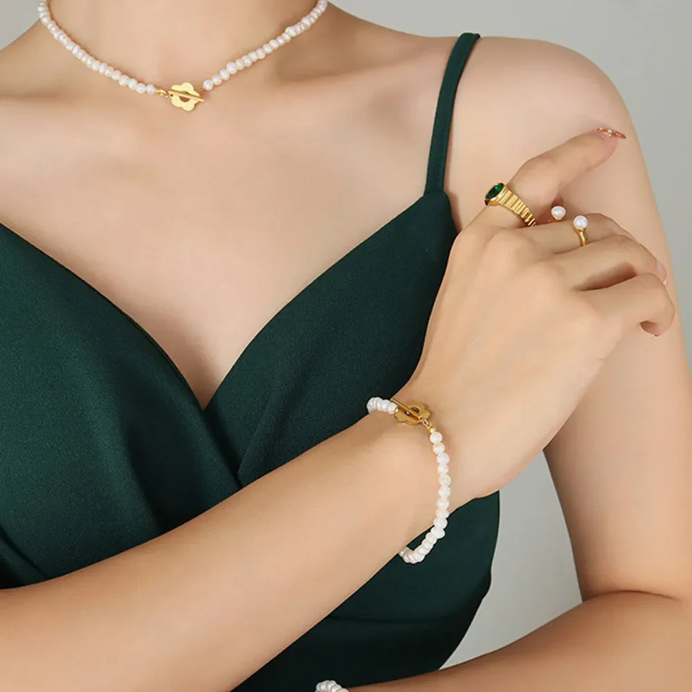 Gold floral clasp freshwater pearl necklace and bracelet with pearl ring.