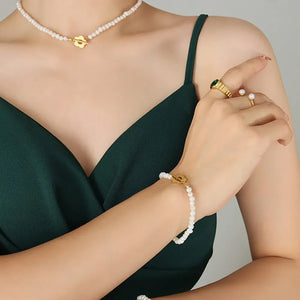Gold floral clasp freshwater pearl necklace and bracelet with pearl ring.