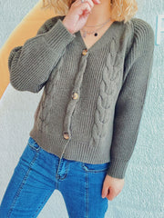 Sage cable knit raglan cardigan with button front and puff sleeves.