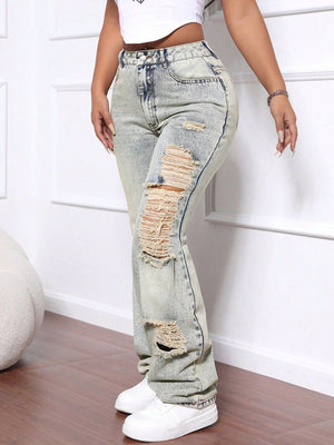 Distressed wide-leg acid wash jeans in light denim with ripped details.
