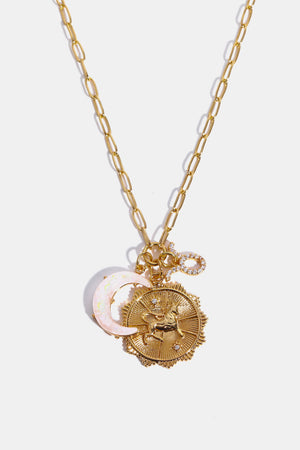 Gold celestial zodiac pendant necklace with moon and unicorn charms.