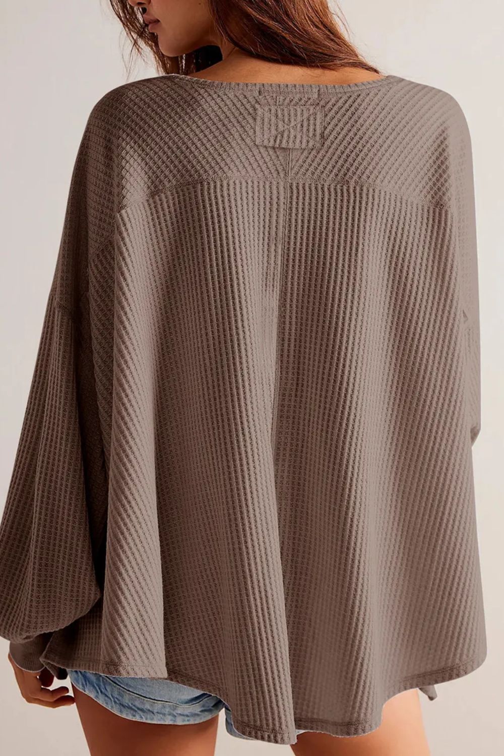 Waffle knit blouson sleeve top in mocha with a relaxed fit and unique yoke detail.