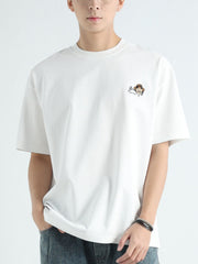 Men's white cotton t-shirt with a small cartoon graphic on the chest.
