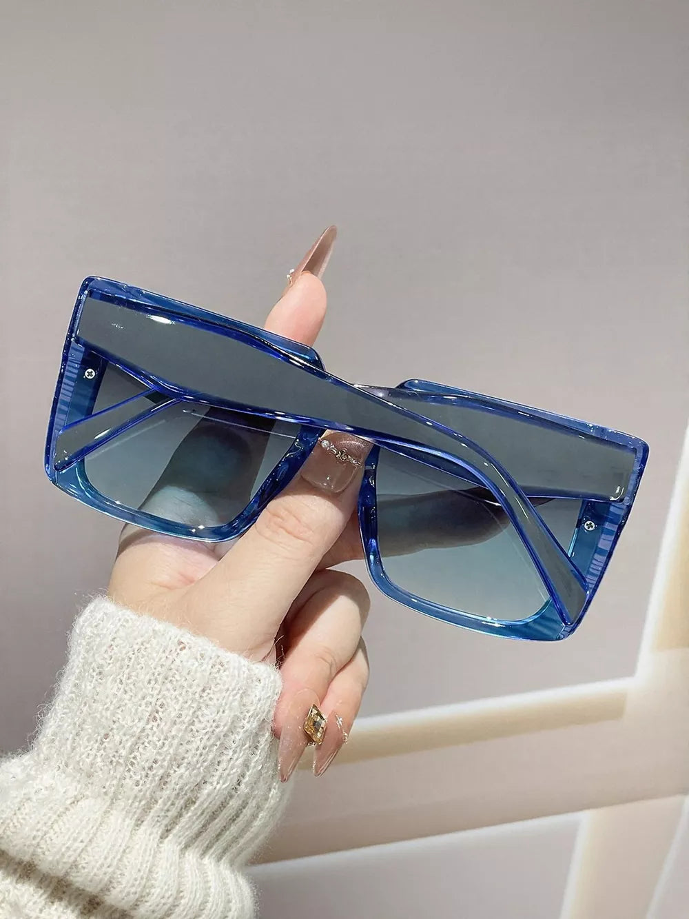 Oversized square blue gradient sunglasses with clear blue frames.