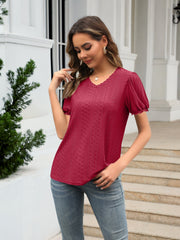 Burgundy eyelet puff sleeve v-neck blouse with textured pattern and lace trim.