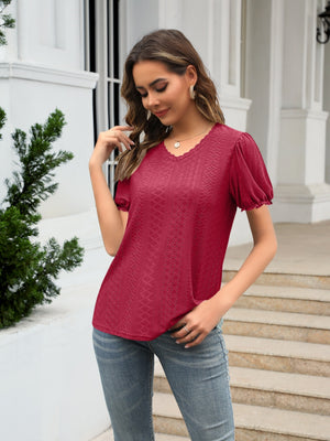 Burgundy eyelet puff sleeve v-neck blouse with textured pattern and lace trim.