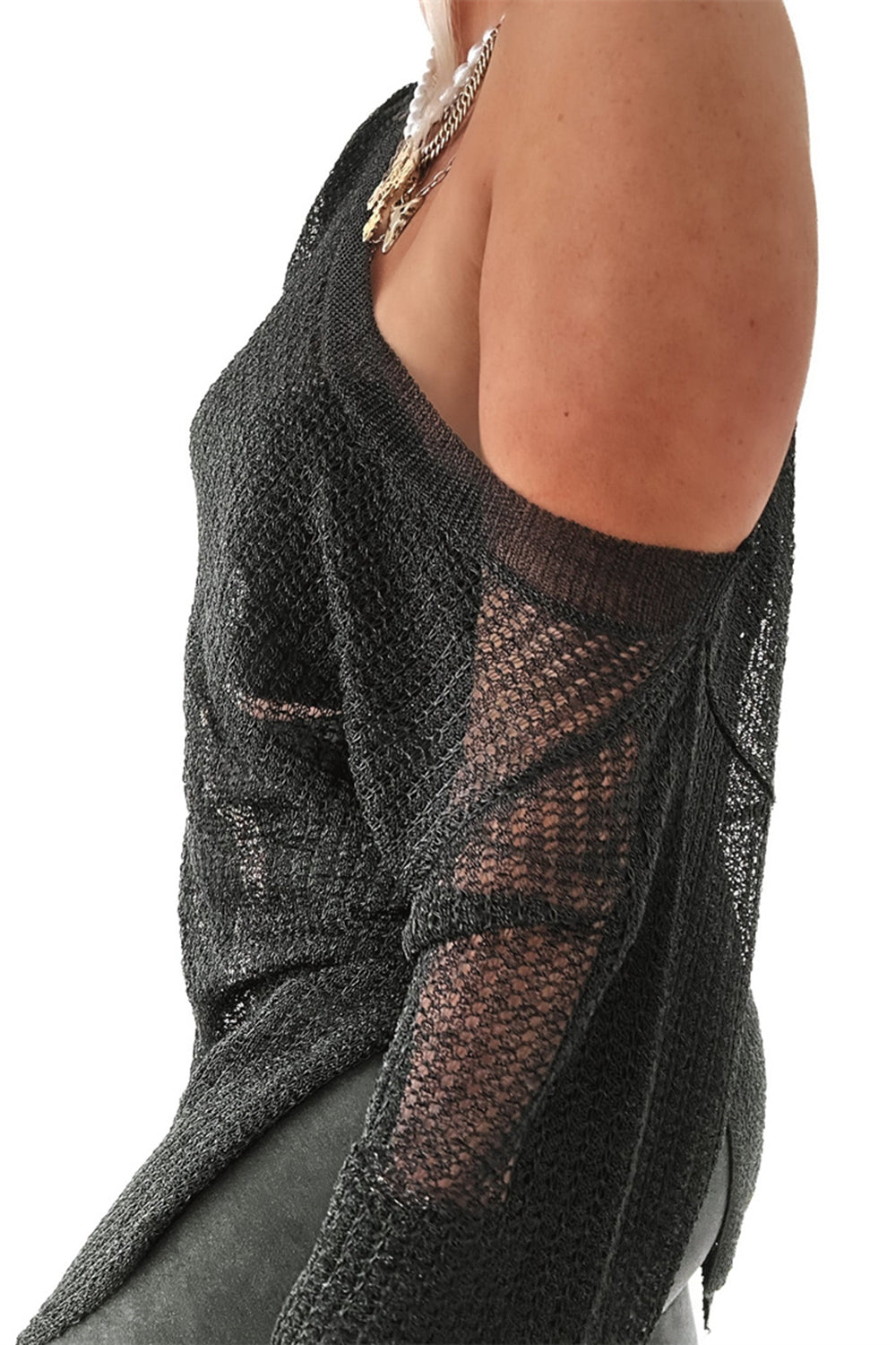 Black off-shoulder metallic knit top with a slit detail and sheer sleeves.