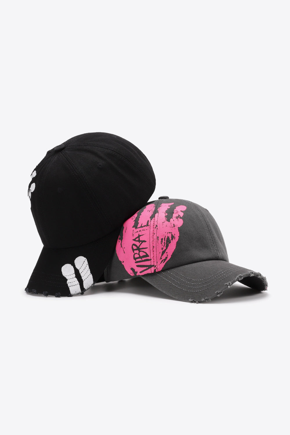 Black and dark gray baseball caps with distressed details and graffiti art.
