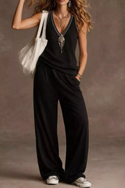 Black V-neck tank with embroidered trim and wide-leg pants with elastic waist